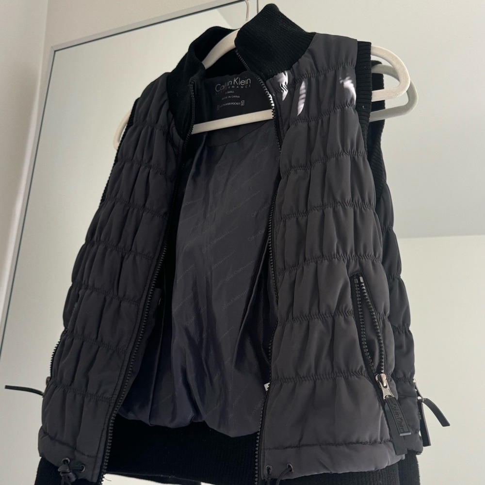 Calvin Klein Black puffer jacket with hood, perfect for winter.